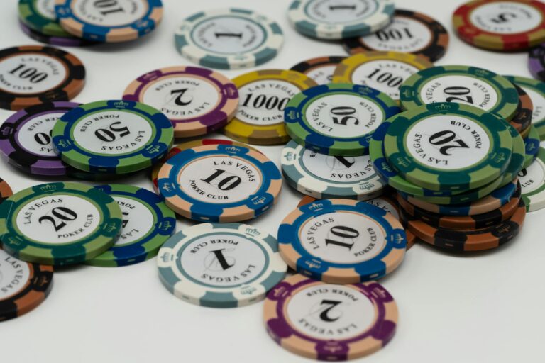 Close-up of colorful Las Vegas poker chips scattered on a table.