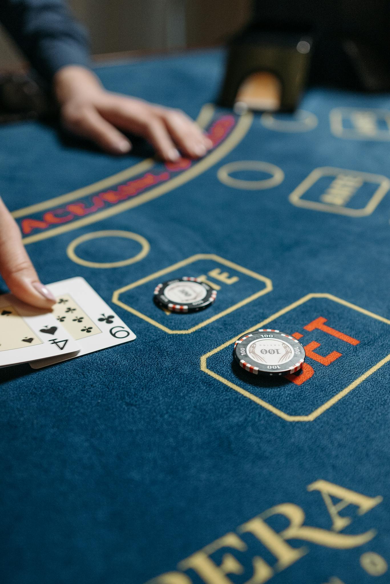 High-stakes card game on a casino table featuring poker chips and a dealt hand.